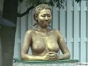 Green Japanese garden statue has tits felt up