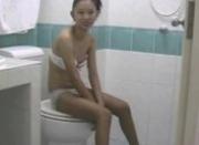 Oriental teen gives bj in the toilet
