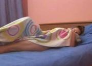 Sleepy brunette in bed