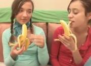Teen girls eat bananas