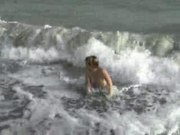 Tigra's terrific body tossed around in the surf