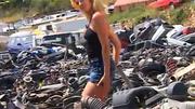 Chloe brightens up a junk yard with her naked body