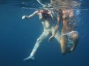 Underwater in the sea young babes swimming nude