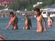 Nudist girls have fun with each other at the beach