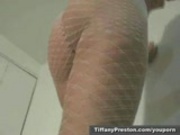 Hot babe Tiffany stripping in fishnet suit 