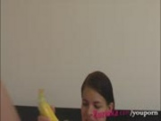 How-to: Young brunette girl teaches using a banana 