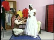 Dress maker checks the seems in her dress