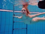 Teen girl Avenna is swimming in the pool