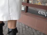 Girl corrects stockings in front of showcase