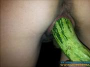 Brunette fucking a huge vegetable as dildo