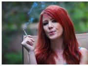Woman smokes outdoors