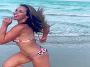 Mickie James running on a beach in a bikini. WWE, TNA.