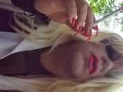 Crossdresser smoking with long red nails