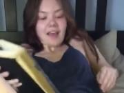 Girl pees on bed while reading a book