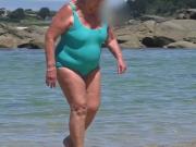 beautiful sexy granny in the wet turquoise swimsuit