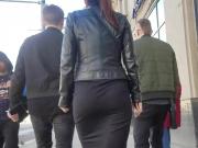 Brunette's ass in black skirt
