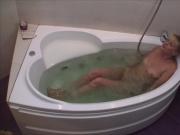 Nerdy blonde gets naked and takes a bath