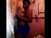 Chubby black woman shows her huge saggy tits