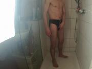 guy in black speedo in shower