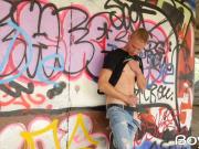 Young guy masturbates in public in front of graffiti wall