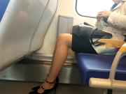 Young woman wearing nude pantyhose in train