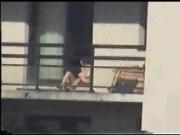 Neighbor sunbathing on balcony 2