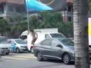 Naked crazy girl jumping over cars in the street