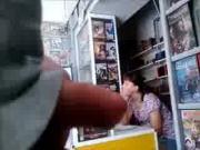 Flasher in video shop near to assistant