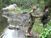 Two military lads resting by the river