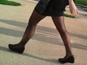 Sexy legs in miniskirt and black pantyhose candid