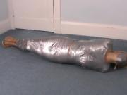 Blonde girl wrapped in duct tape struggles