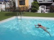 Adult woman bathing in the pool naked