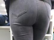 Big sexy ass of a saleswoman in tight jeans in a store