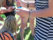 clothed girls do hand painting on a naked guy CFNM