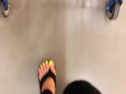 Mature feet walking in platform flip flops