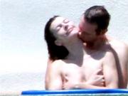 Milla Jovovich in the Pool with her Husband - Slideshow