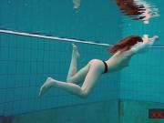 Pierced teen swimming