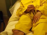 Filling up a condom in a yellow raincoat