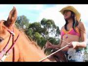 Cute Carla rides a horse in bikini