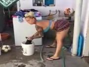 sexy lady dancing while washing clothes