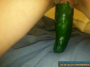 Petite brunette riding a huge cucumber