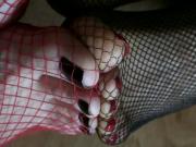 Double foot play in fishnet stockings