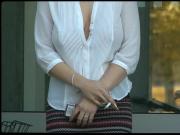 Smoking in a loose blouse