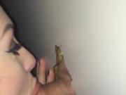 Tatted up chick sucks it good through a glory hole