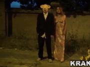 Submissive MILF on the street with man with a pig mask