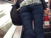 Denim jeans ass going up the escalator