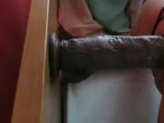 Fucking herself with a Big Black Dildo