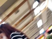 Girl in tight jeans in the supermarket in Slow Motion