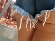 Young girl in shorts with butt out in the butcher shop
