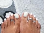 Ebony showing feet with white toe nails
